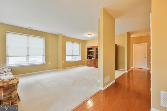 unfurnished living room with hardwood / wood-style floors and a healthy amount of sunlight