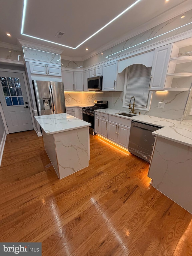 kitchen featuring a center island, stainless steel appliances, and white cabinetry