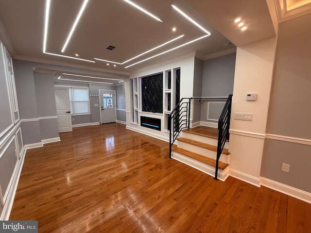 foyer entrance featuring wood-type flooring and ornamental molding