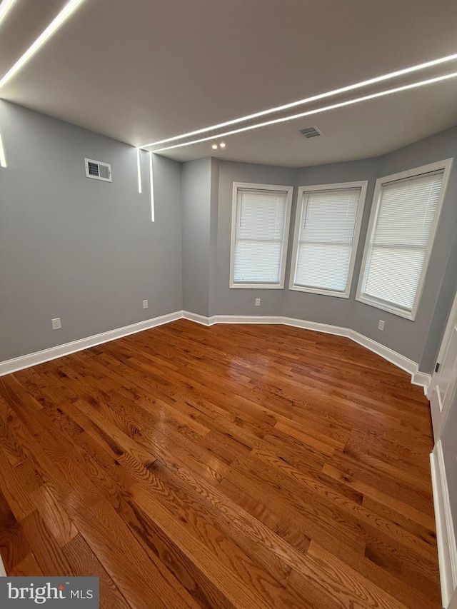 empty room with hardwood / wood-style flooring