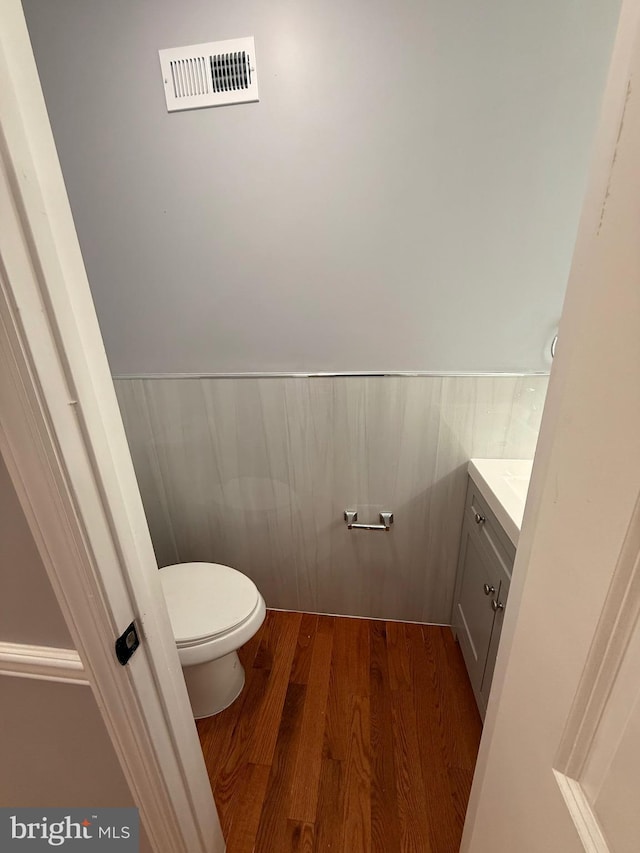 5111 Warrington Ave, Philadelphia, PA 19143 - bathroom with vanity, wood finished floors, and a wainscoted wall