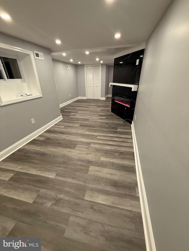 basement with hardwood / wood-style flooring