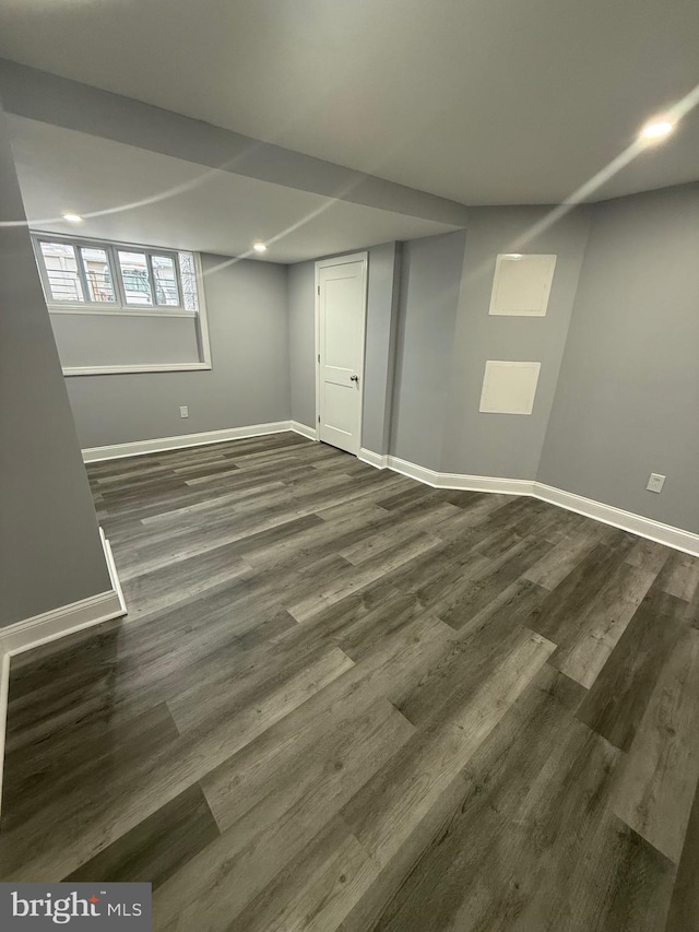 basement featuring dark hardwood / wood-style flooring