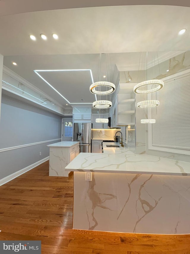 5111 Warrington Ave, Philadelphia, PA 19143 - kitchen with stainless steel fridge, dark wood-style flooring, a sink, open shelves, and a center island