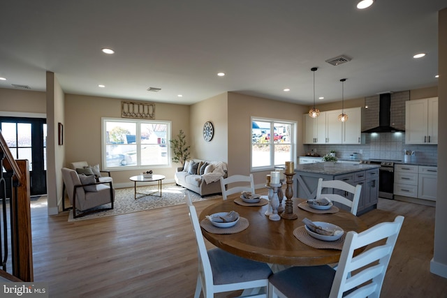 dining space featuring a healthy amount of sunlight and light wood-type flooring