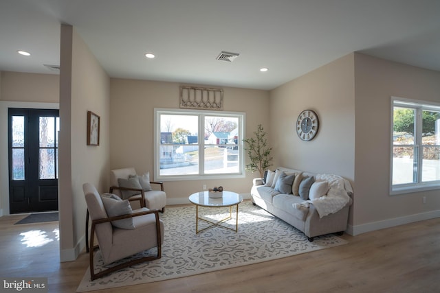 living room with french doors and light hardwood / wood-style flooring