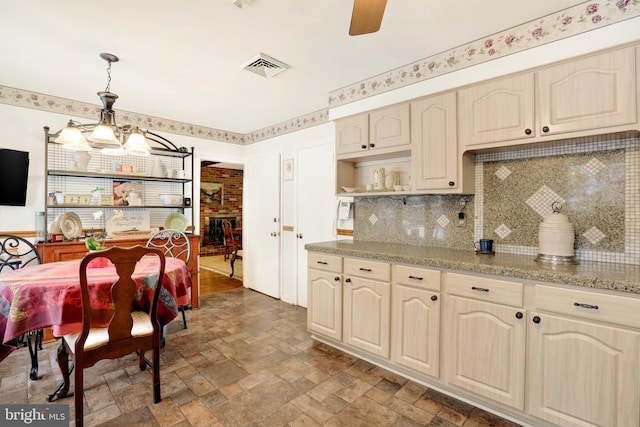 kitchen with pendant lighting, open shelves, visible vents, a ceiling fan, and stone finish floor