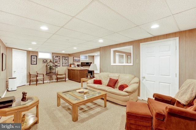 living area featuring carpet floors, wood walls, and recessed lighting