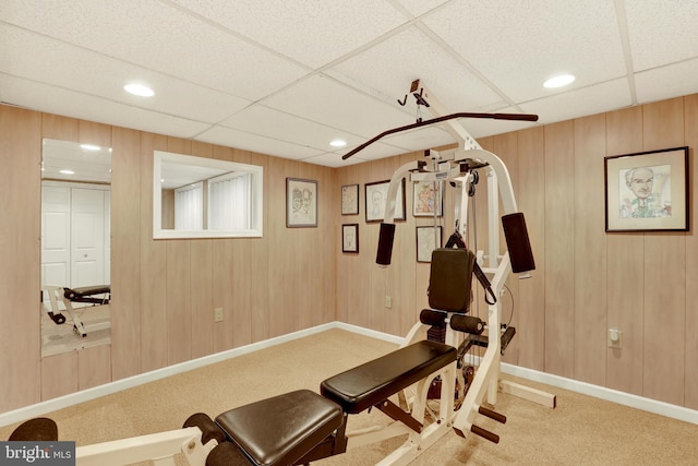 exercise room featuring a paneled ceiling, carpet, baseboards, and recessed lighting