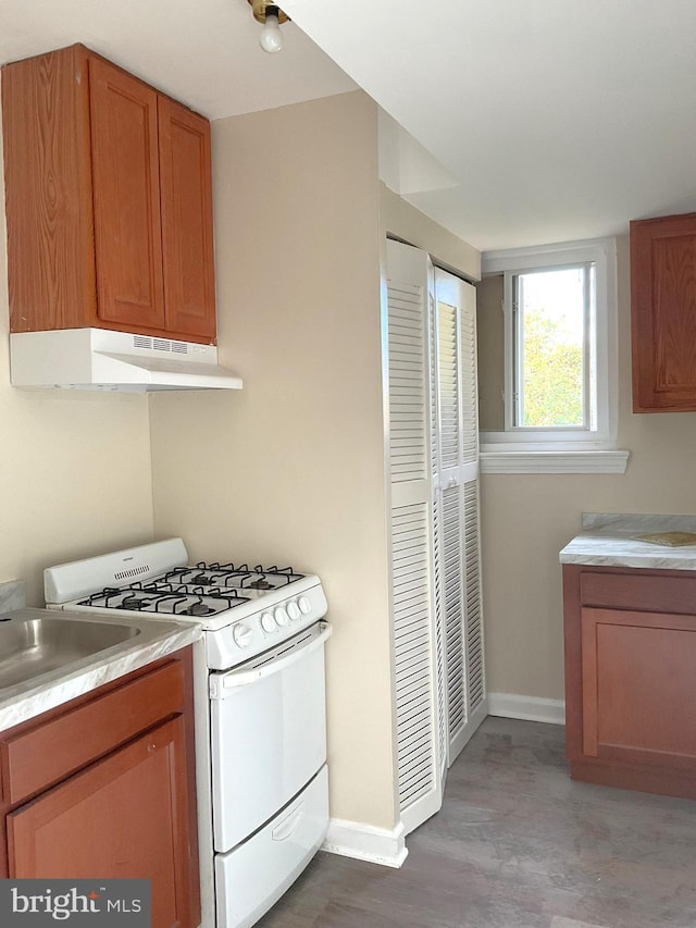 kitchen with gas range gas stove and hardwood / wood-style flooring