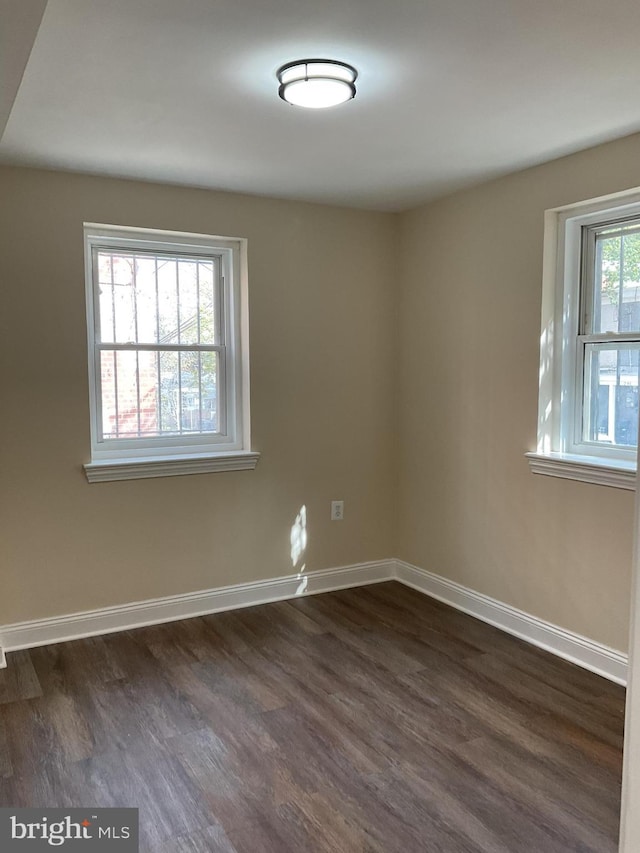 empty room with dark hardwood / wood-style floors