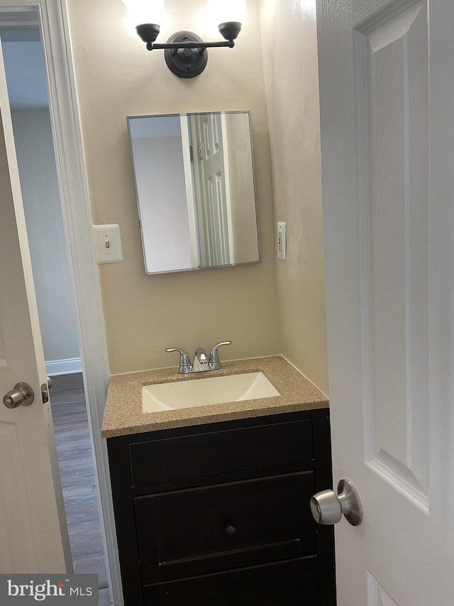 bathroom featuring hardwood / wood-style floors and vanity