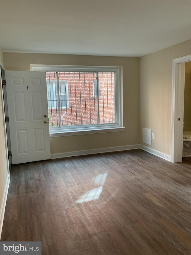 interior space with dark hardwood / wood-style floors and plenty of natural light