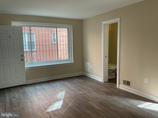 empty room featuring dark wood-type flooring