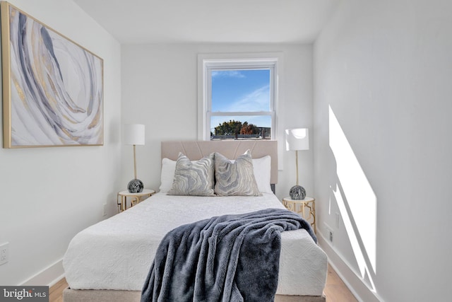 bedroom with hardwood / wood-style flooring