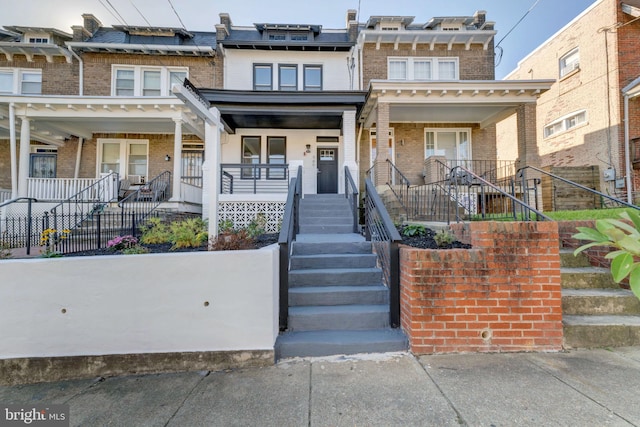 view of property featuring covered porch