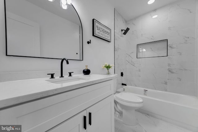 full bathroom with vanity, tiled shower / bath combo, and toilet