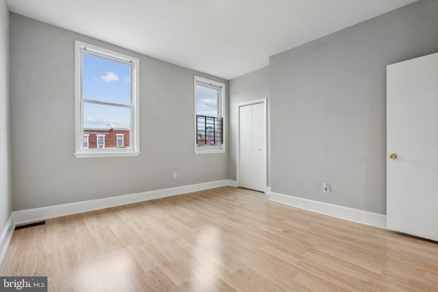 spare room featuring light wood-type flooring