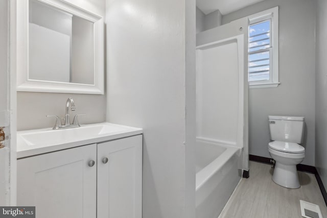 bathroom with toilet, vanity, and hardwood / wood-style flooring