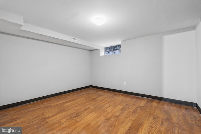 basement with hardwood / wood-style flooring