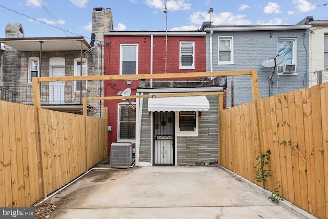 back of property with cooling unit and central air condition unit