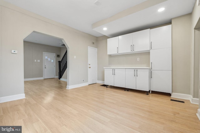 kitchen with white cabinets and light hardwood / wood-style floors