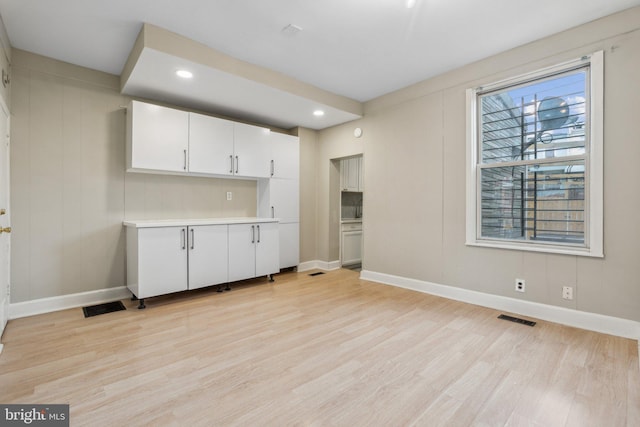 kitchen featuring white cabinets and light hardwood / wood-style floors