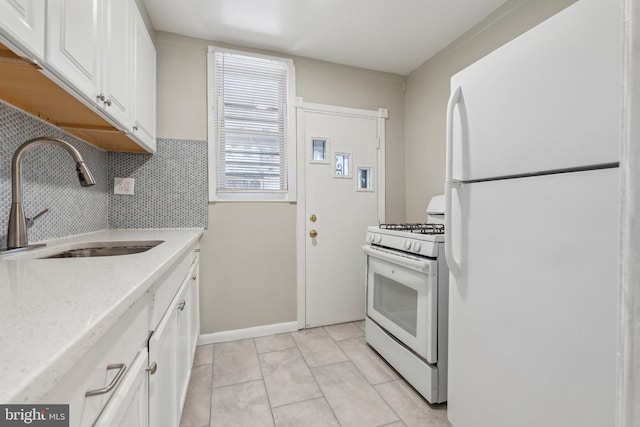 kitchen featuring white cabinetry, sink, backsplash, white appliances, and light tile patterned flooring