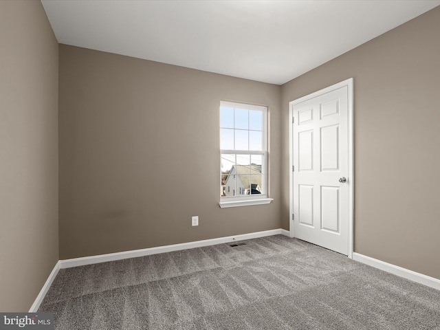 unfurnished room featuring carpet flooring