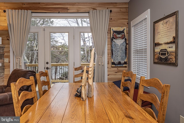 dining area featuring wooden walls