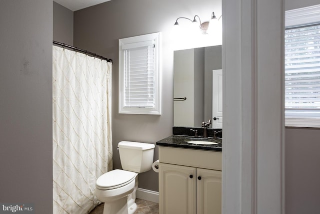 bathroom featuring tile patterned flooring, vanity, and toilet