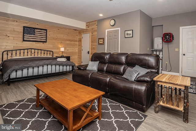 bedroom featuring wooden walls and hardwood / wood-style floors