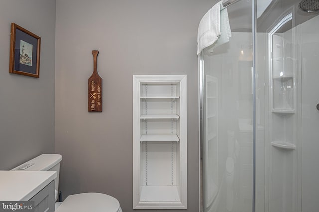 bathroom featuring vanity, toilet, and walk in shower