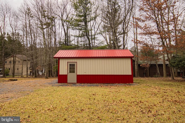 view of outbuilding with a lawn