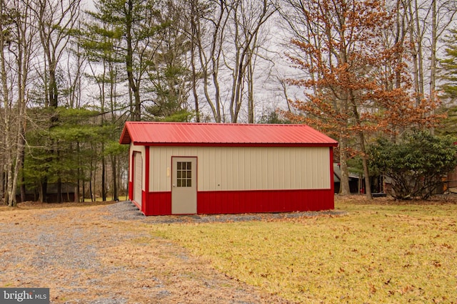 view of outdoor structure featuring a lawn