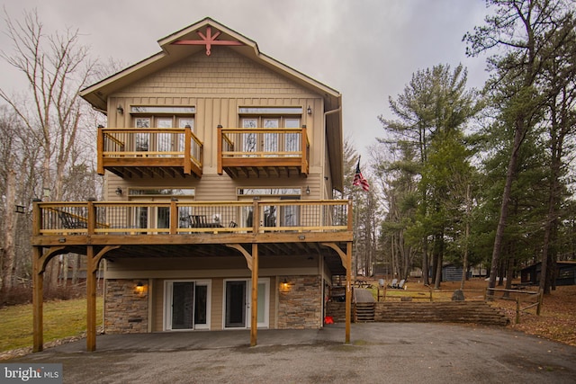 back of property featuring a deck