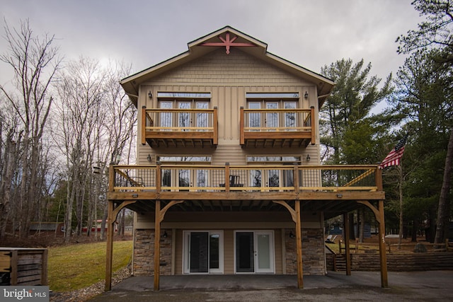 rear view of property featuring a wooden deck