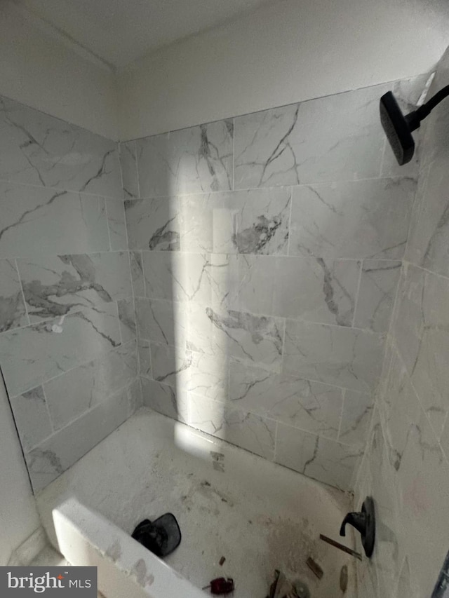 bathroom with a tile shower