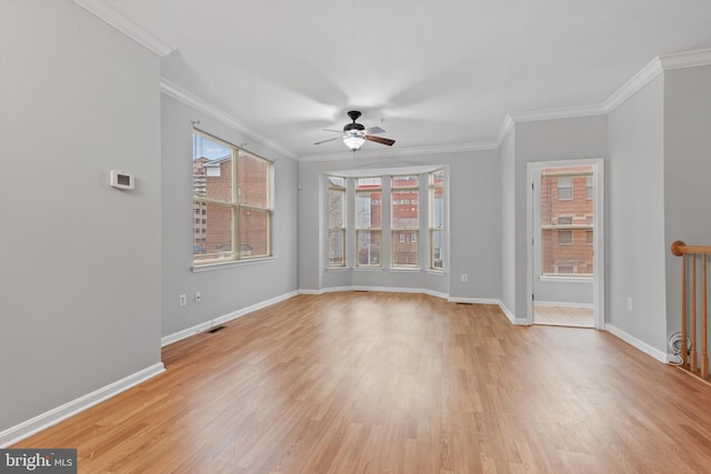 spare room with crown molding, ceiling fan, and light wood-type flooring