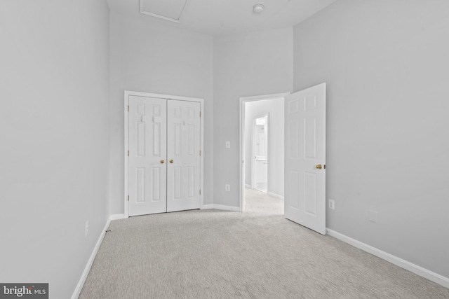 spare room with light carpet and a high ceiling