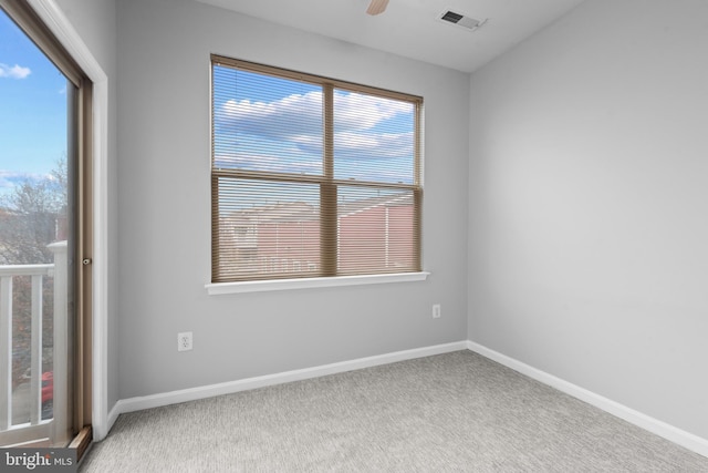 empty room featuring carpet flooring and a healthy amount of sunlight