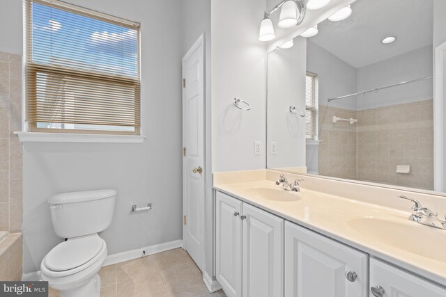 bathroom with walk in shower, tile patterned flooring, vanity, and toilet