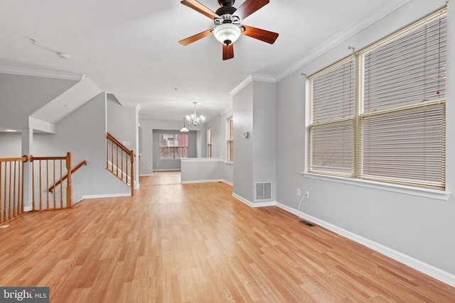 unfurnished living room featuring crown molding, light hardwood / wood-style floors, and ceiling fan with notable chandelier