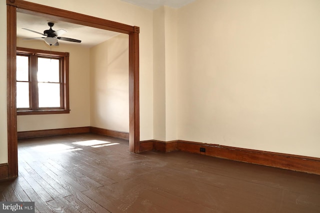 empty room with dark hardwood / wood-style floors and ceiling fan