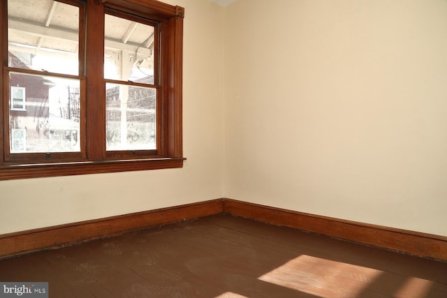 empty room with dark wood-type flooring