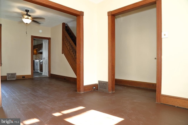 spare room featuring ceiling fan and dark wood-type flooring