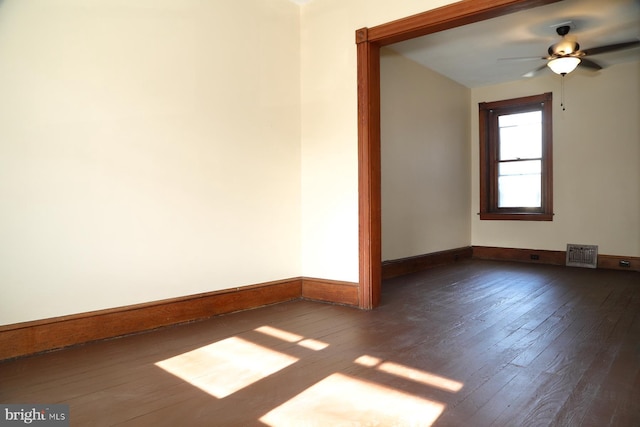 unfurnished room featuring dark hardwood / wood-style floors and ceiling fan