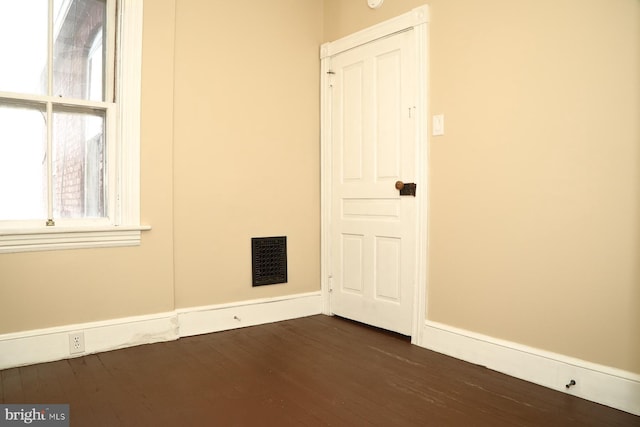 unfurnished room featuring dark hardwood / wood-style floors