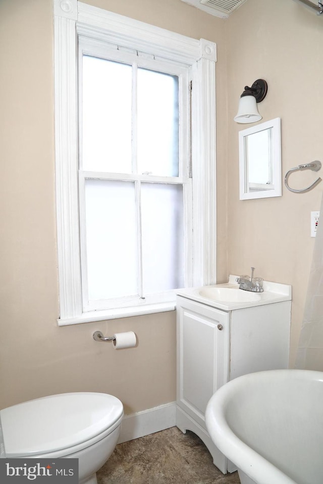 bathroom featuring vanity and toilet