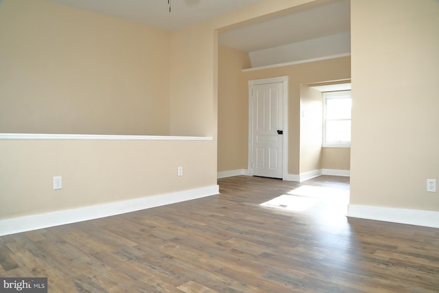 unfurnished room with hardwood / wood-style flooring